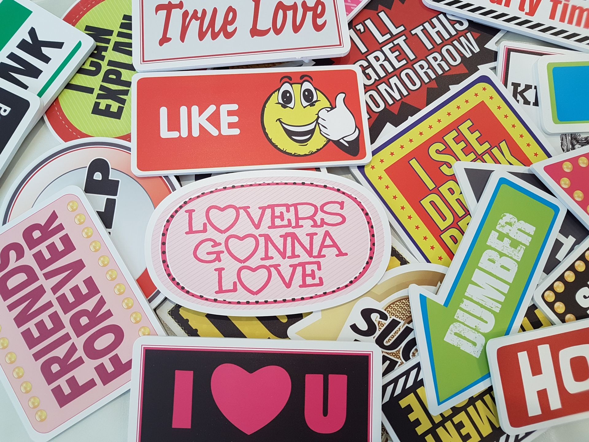 Pile of colorful stickers with various positive and humorous messages and graphics.