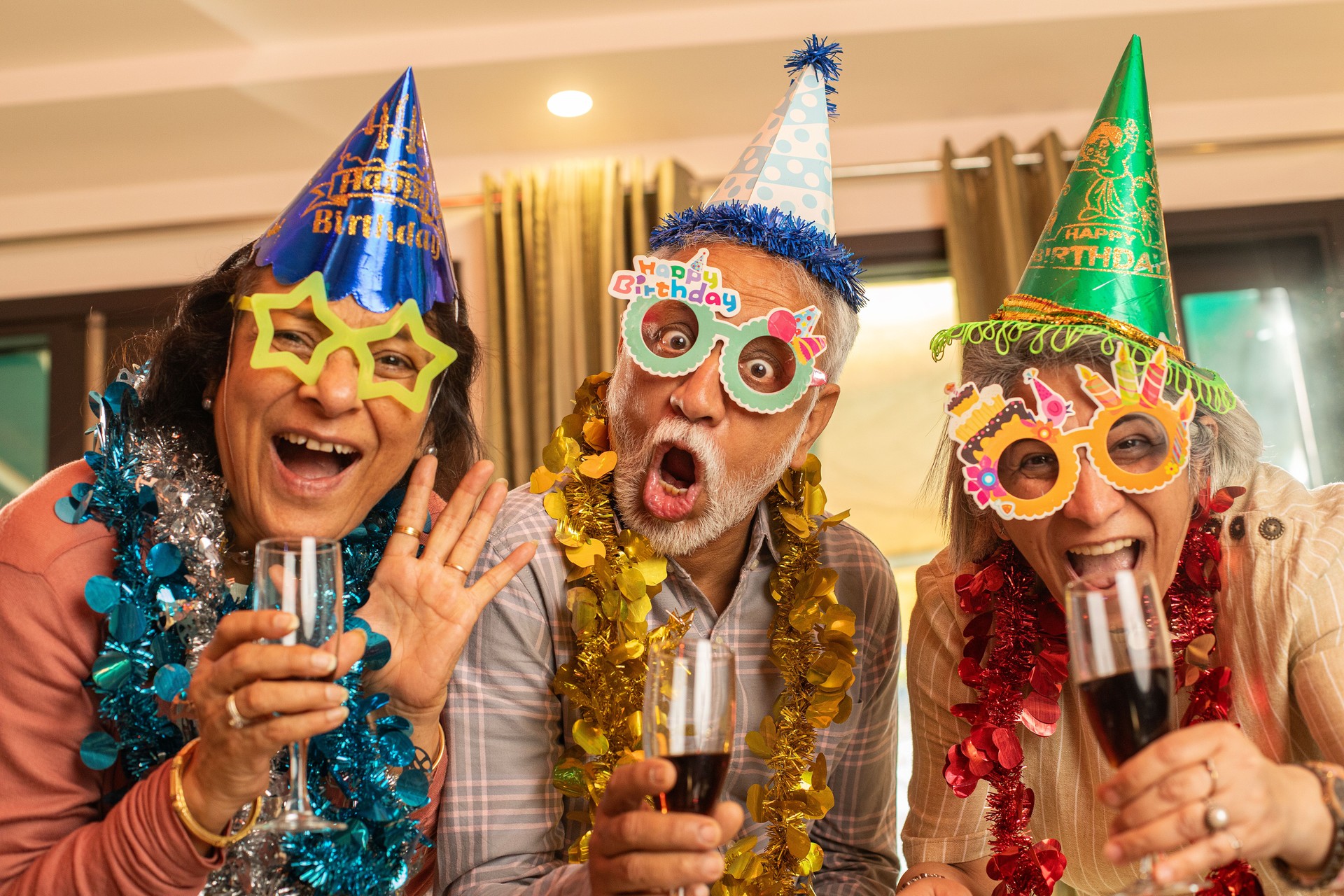 Old friends enjoying drinks at house party